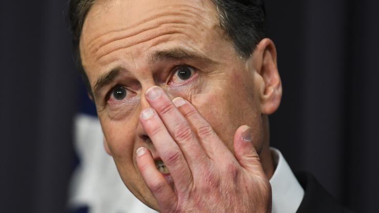 Australian Health Minister Greg Hunt wipes away a tear during a press conference at Parliament House in Canberra.