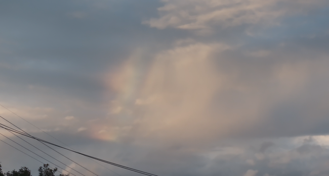 A screenshot of a rainbow from a video recording. 